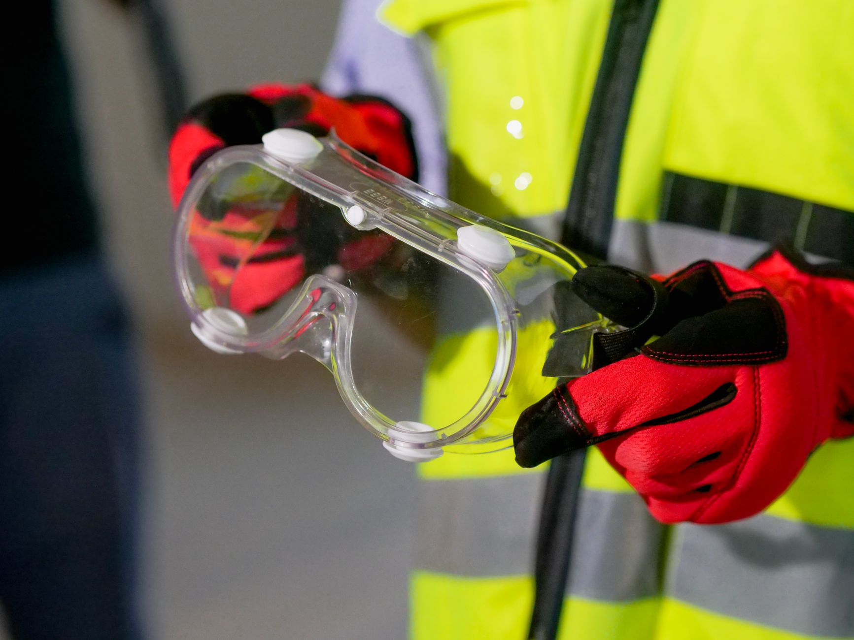 close up photo of person holding safety glasses