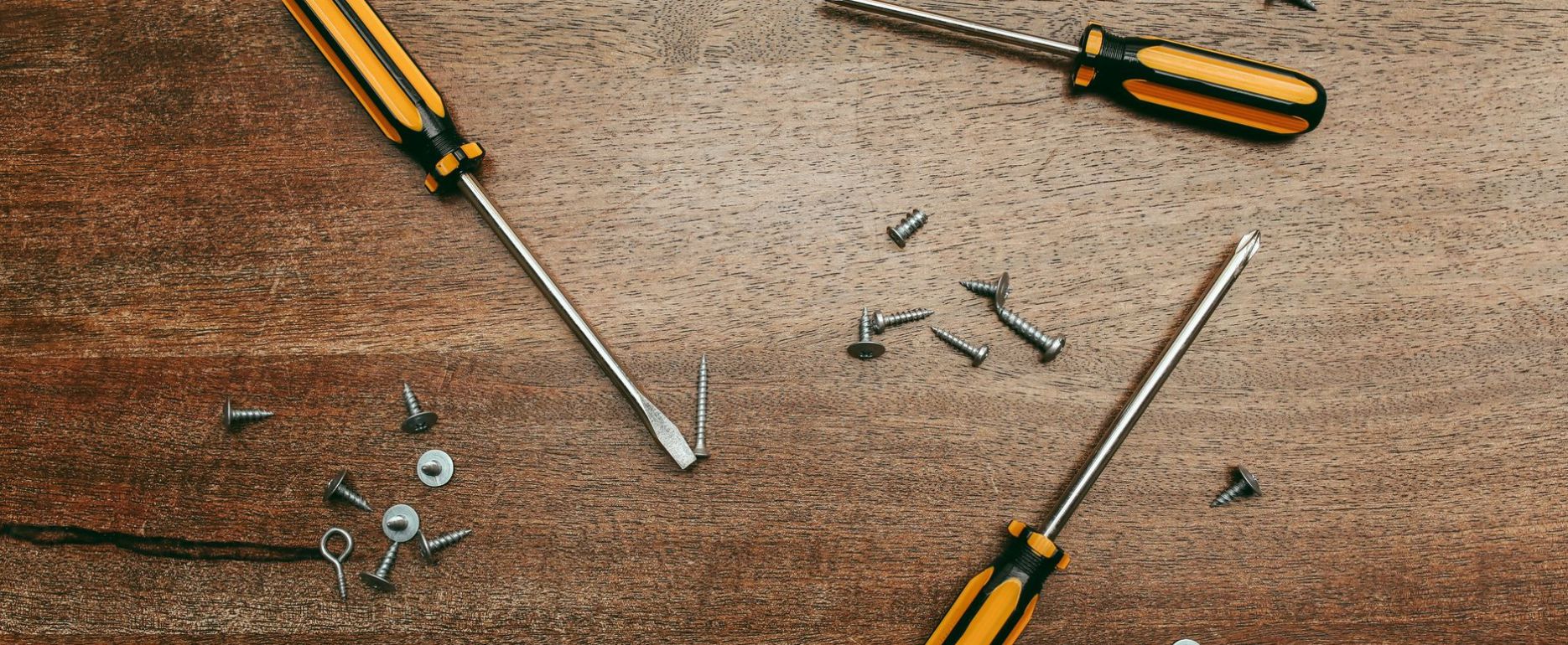 scattered screwdrivers and screws