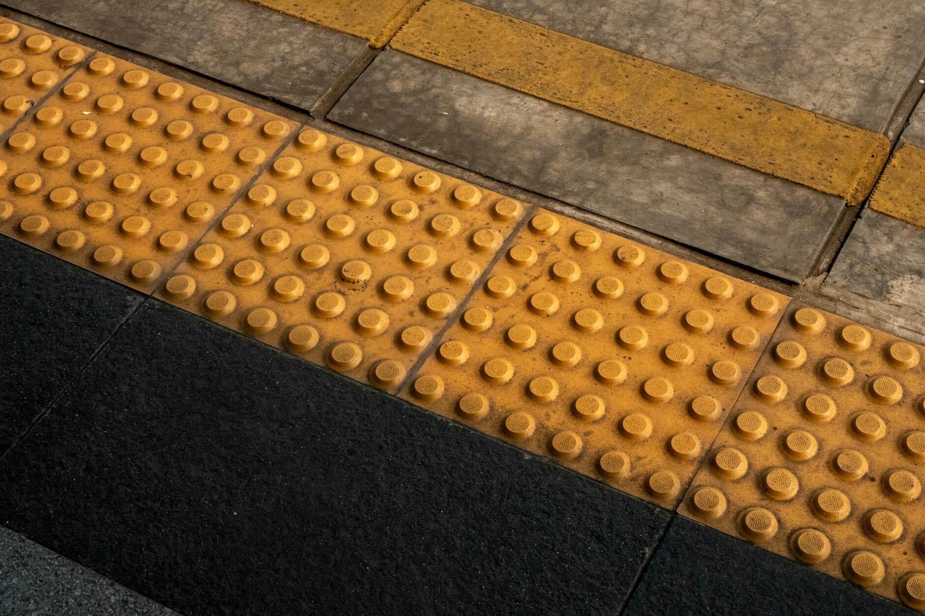 close up of accessibility guiding blocks at station