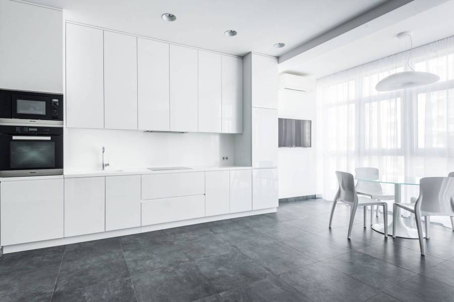 white dining chairs and table near white cabinets