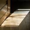 a rectangular sunlight cast on parquet floor