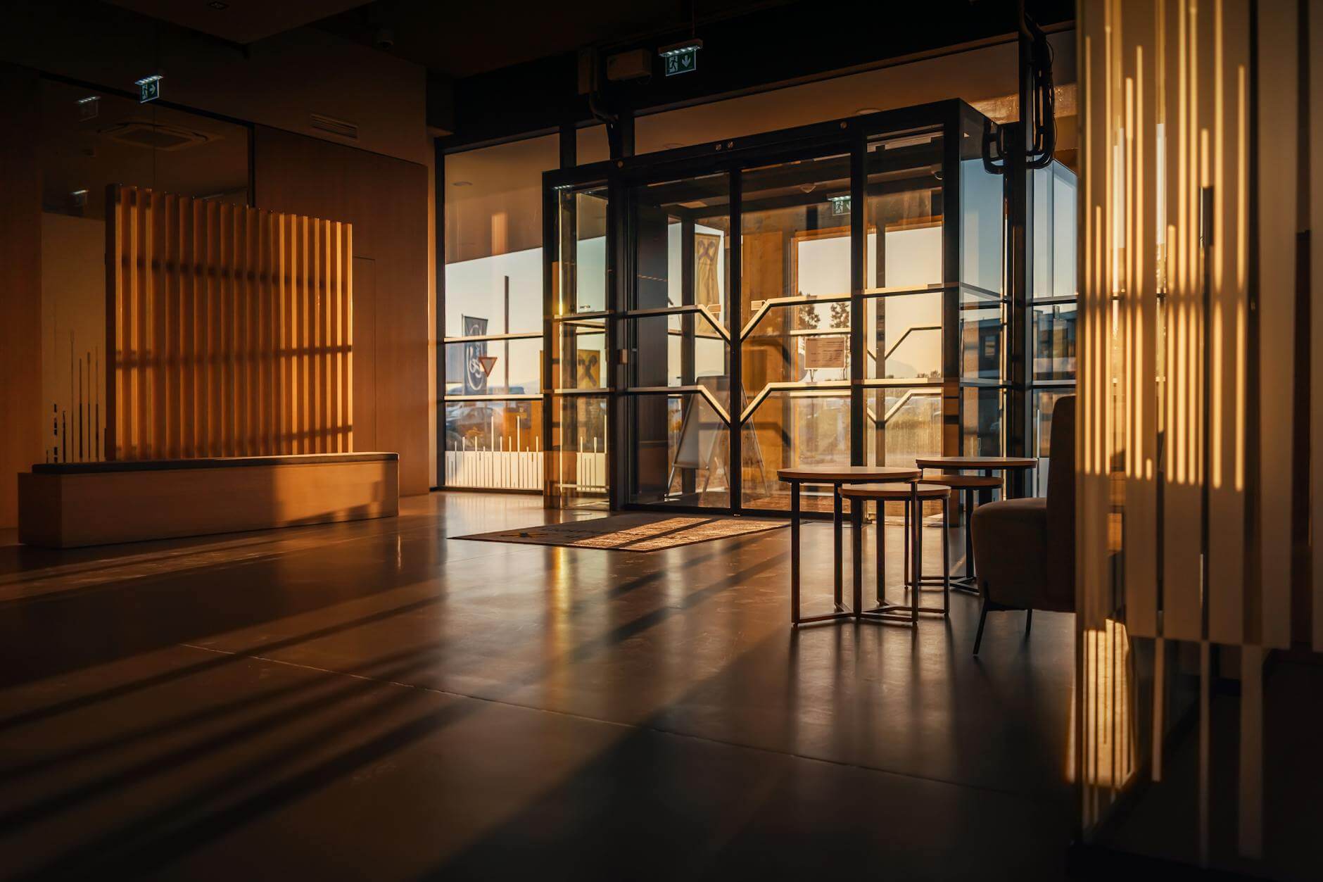 light of the setting sun streaming into the lobby through the glass double doors