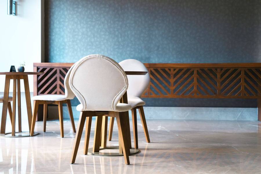 white chairs and a wooden table in a cafe