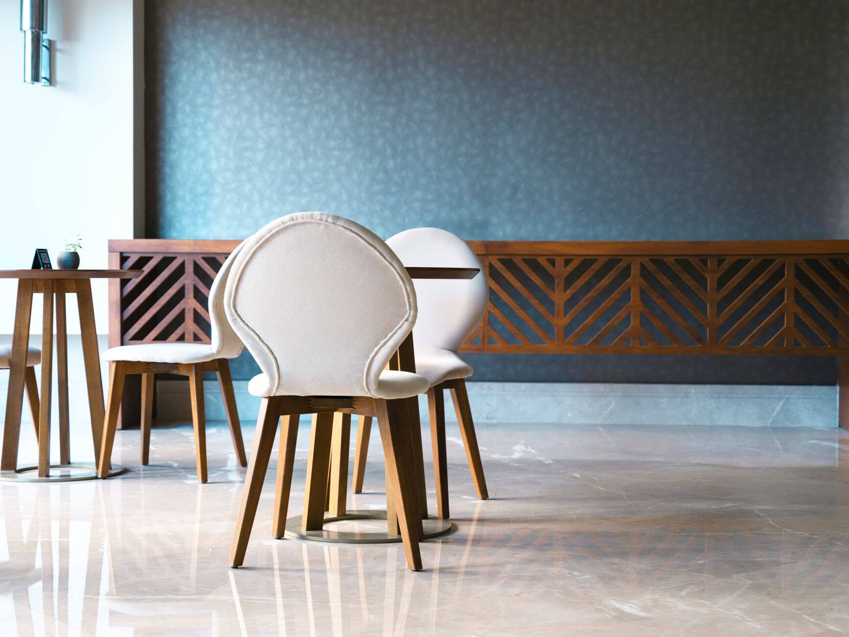 white chairs and a wooden table in a cafe