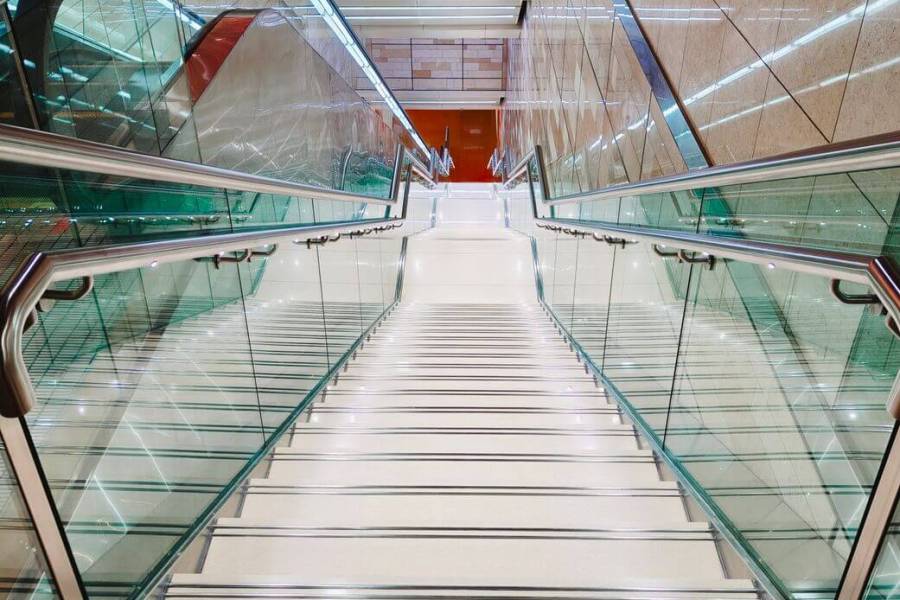 modern indoor staircase with glass railings