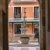 elegant fountain through stone archway