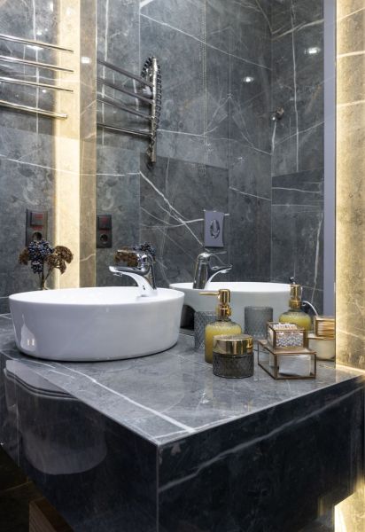 bathroom interior with washbasin reflecting in mirror