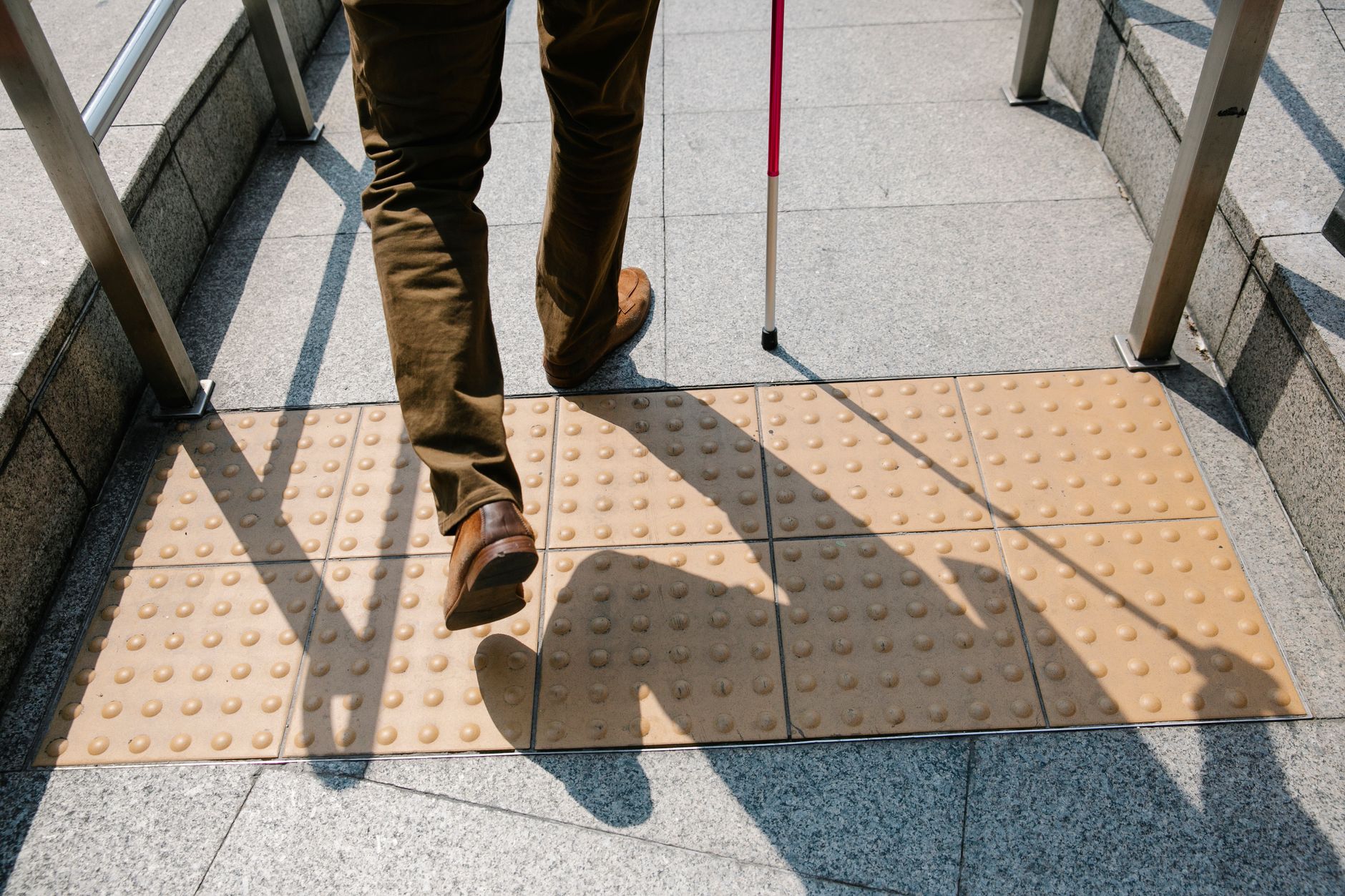 photo of person using cane as a walking guide